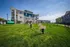 Modern apartment complex with versatile outdoor dog park and seating area, perfect for pet lovers.