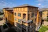 Charming modern apartment building with vibrant yellow and brown fa&ccedil;ade, expansive windows, and inviting balconies.