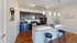 Elegant kitchen with dark wooden cabinets, sleek granite countertops, and modern pendant lighting.