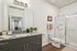 Modern bathroom with elegant granite countertop, sleek fixtures, and a spacious glass-enclosed shower.