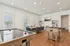 Bright and inviting game room featuring air hockey and foosball tables, cozy seating area, and modern decor with ample natural light.