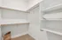 Spacious walk-in closet with ample shelving and elegant design, perfect for organizing clothes and accessories.