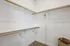 Spacious walk-in closet with ample shelving and hanging space, perfect for organizing your wardrobe.