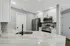 Modern kitchen with sleek stainless steel appliances, granite countertops, and elegant cabinetry.