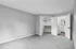 Spacious bedroom with plush carpeting, featuring a large walk-in closet and modern en-suite bathroom.