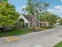 Charming community center surrounded by lush greenery and vibrant landscaping, perfect for welcoming residents.