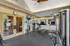 Inviting fitness center featuring modern gym equipment, natural lighting, and serene decor.