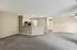Spacious open-plan living area with modern kitchen, featuring sleek appliances and ample natural light, ideal for comfortable living.