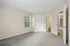 Bright, spacious bedroom with plush carpeting, neutral walls, and ample closet space, perfect for comfortable living.