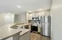 Modern kitchen with sleek stainless steel appliances, expansive granite countertops, and elegant wood cabinets offering a stylish, functional cooking space.