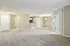 Bright open living space with plush carpet, modern kitchen, and large patio doors.
