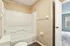 Charming bathroom featuring modern fixtures, a sleek bathtub, and large window for natural light.