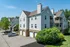 Charming apartment building featuring modern architecture, lush landscaping, and convenient parking.