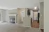 Inviting open-concept living space with elegant fireplace, modern kitchen, and ample natural light.