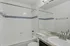 Modern bathroom featuring a sleek bathtub, elegant tile design with blue accents, and contemporary vanity with a stylish faucet.