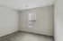 Bright, cozy room with soft carpet flooring and a large window, perfect for a peaceful retreat.