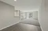 Bright and spacious living area featuring elegant hardwood floors, a cozy fireplace, and sliding doors opening to a serene outdoor view.