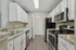 Modern kitchen with sleek stainless steel appliances, elegant cabinetry, and wood-style flooring creating a stylish and functional culinary space.