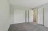 Inviting bedroom with soft gray carpeting and crisp white doors, ready for personalization and comfort.