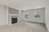 Bright and inviting living room with plush carpet, elegant fireplace, and large windows providing natural light.