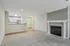 Inviting open-concept living space with cozy fireplace and modern kitchen, perfect for entertaining.