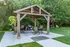 Charming outdoor patio with a wooden pergola, elegant seating, and lush greenery, perfect for relaxing and entertaining.