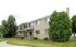 Charming multi-unit apartment building with private balconies and lush greenery, offering tranquility and modern living.