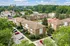Charming apartment complex with lush greenery, a sparkling swimming pool, and ample parking, surrounded by tranquil natural beauty.