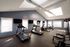 Bright, modern fitness center featuring state-of-the-art treadmills, elliptical machines, and a variety of free weights. Enjoy your workout in a spacious, skylit room with natural light.