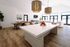 Bright and stylish open-plan living area featuring a modern kitchen island, elegant dining set, and chic lighting fixtures, perfect for entertaining.