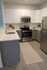 Modern kitchen design featuring sleek stainless steel appliances, elegant white cabinetry, and a chic subway tile backsplash.