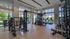 Modern fitness center with large windows, state-of-the-art gym equipment, and serene outdoor views for an energizing workout experience.