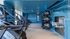 Modern fitness center with state-of-the-art cardio machines, vibrant blue walls, and a selection of exercise balls and equipment.