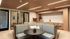 Modern communal lounge with cozy seating, elegant decor, and a sleek kitchenette area.