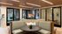 Modern office space with sleek seating arrangements, stylish lighting, and floor-to-ceiling glass walls.