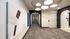 Modern apartment hallway featuring elegant archways, stylish lighting, and contemporary artwork.