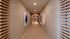 Sleek modern hallway with stylish art pieces and wooden accents, perfect for a contemporary apartment ambiance.