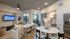 Modern open-concept apartment with a cozy living area, elegant dining space, and sleek kitchen, featuring large windows and stylish decor.
