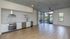Modern open-concept kitchen and living area with sleek cabinetry, marble backsplash, and expansive windows offering abundant natural light.
