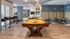Modern apartment community lounge featuring a stylish pool table, cozy seating areas, and sleek modern lighting.