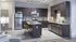 Modern kitchen with dark wood cabinets, stainless steel appliances, and a chic island with stylish bar stools.