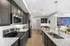 Sleek kitchen with modern appliances, granite countertops, and adjacent dining area featuring stylish decor.