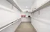 Bright walk-in closet with ample shelving and hanging space, accented by decorative pillows.