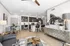 Stylish open-concept living room with modern kitchen and elegant dining set.
