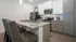 Modern kitchen with sleek granite countertops, high-end stainless steel appliances, and elegant cabinetry, complemented by chic gray bar stools for a stylish dining experience.