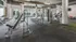 Modern fitness center with sleek gym equipment, natural lighting, and outdoor views, offering a vibrant workout environment.