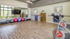 Bright and modern fitness studio featuring exercise bikes, colorful yoga balls, and sleek wooden flooring, perfect for active living.
