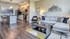 Modern open-concept living space with sleek kitchen, elegant decor, and cozy seating area.