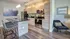 Modern kitchen with sleek wooden cabinets, stainless steel appliances, and elegant pendant lighting above a stylish breakfast bar.
