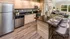 Modern kitchen with sleek stainless steel appliances, elegant wooden cabinetry, and a stylish breakfast bar set for dining.